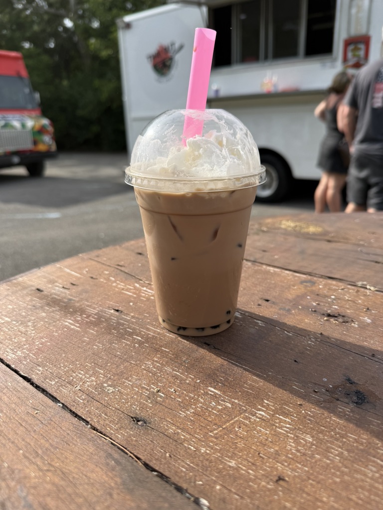 Thai iced tea with boba in front of the truck