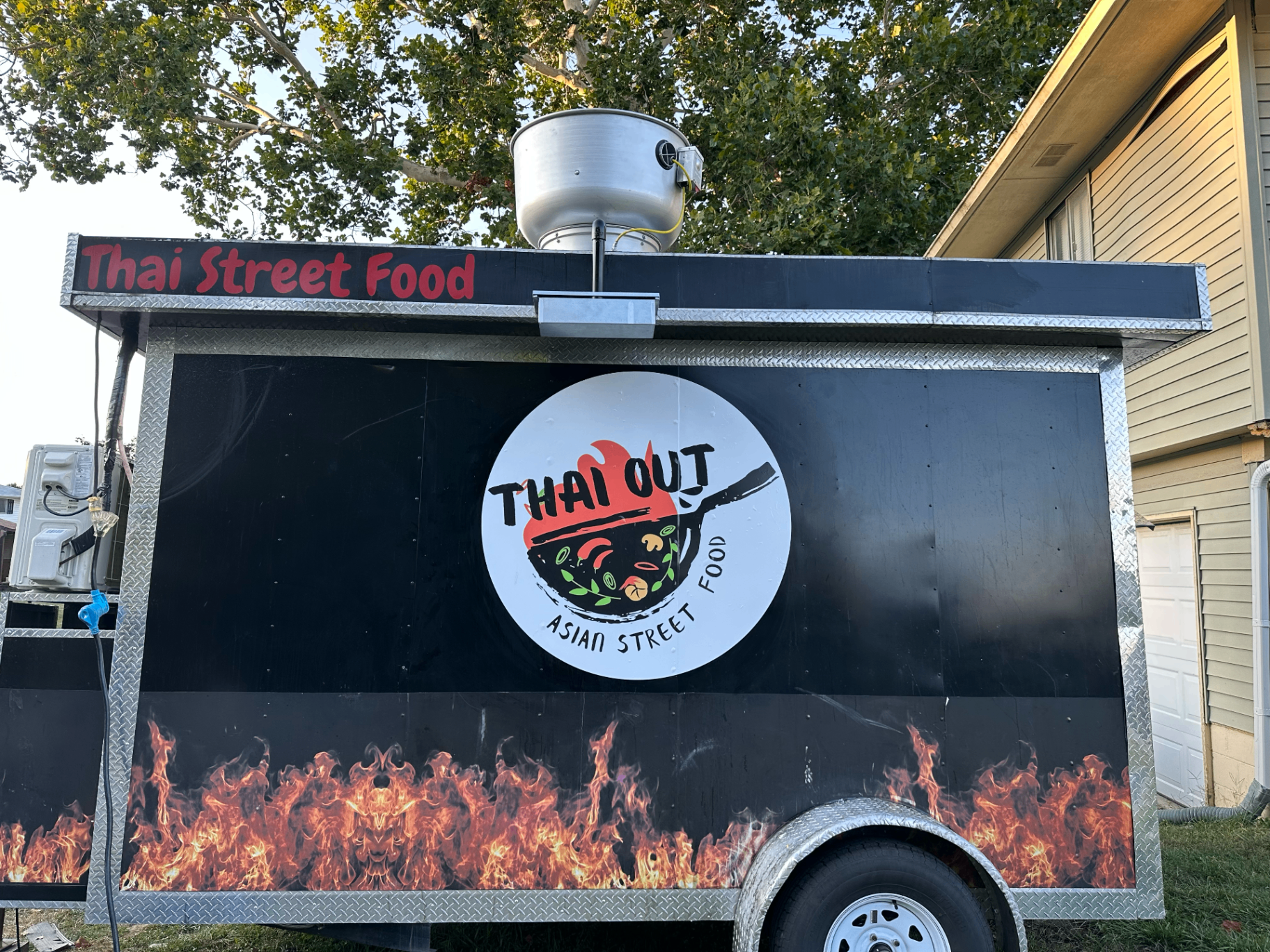 Thai Out trailer with logo and flame wrap